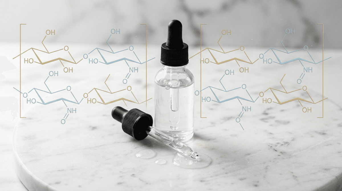 Close-up of a dropper bottle with clear hyaluronic acid serum on a marble surface, surrounded by molecular structure diagrams, soft studio lighting, editorial beauty photography style